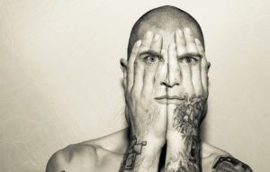man mouth eyes hands tattoo